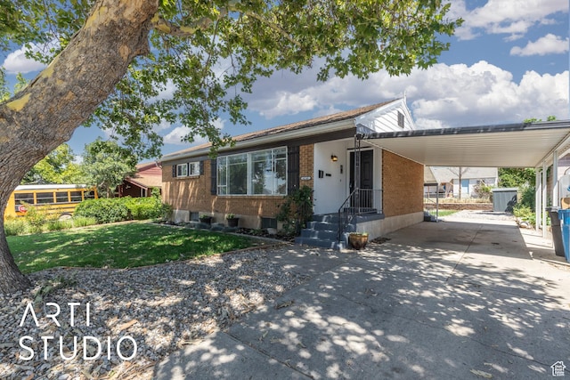 4746 S 250 W, Washington Terrace, UT 84405 - view of front facade with a carport, brick siding, concrete driveway, and a front yard