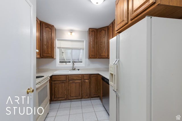 4746 S 250 W, Washington Terrace, UT 84405 - kitchen with white appliances, light tile patterned flooring, light countertops, and brown cabinetry
