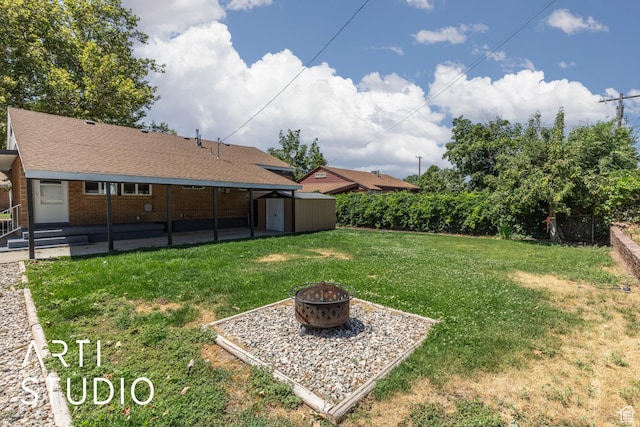 4746 S 250 W, Washington Terrace, UT 84405 - view of grassy yard featuring a fire pit, a storage shed, and a patio area