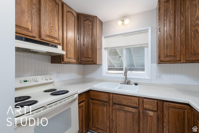 4746 S 250 W, Washington Terrace, UT 84405 - kitchen with white electric stove, under cabinet range hood, light countertops, and brown cabinetry