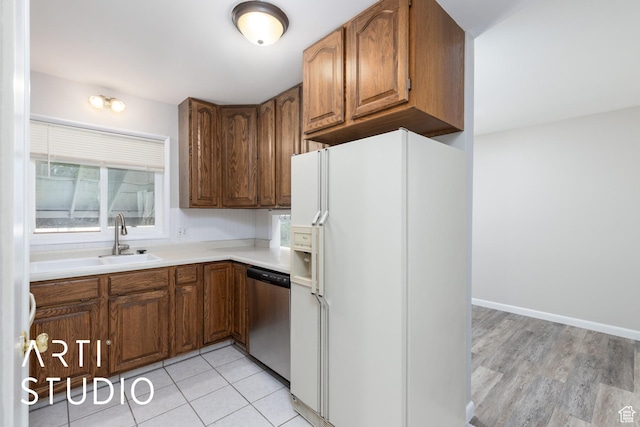 4746 S 250 W, Washington Terrace, UT 84405 - kitchen with white fridge with ice dispenser, brown cabinetry, stainless steel dishwasher, and light countertops