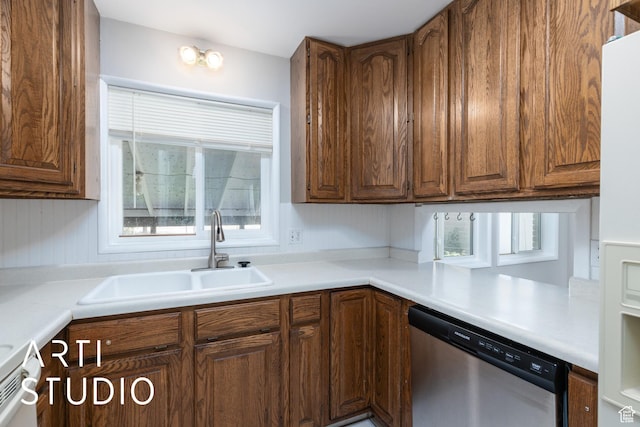 4746 S 250 W, Washington Terrace, UT 84405 - kitchen with stainless steel dishwasher, light countertops, brown cabinetry, and white refrigerator with ice dispenser