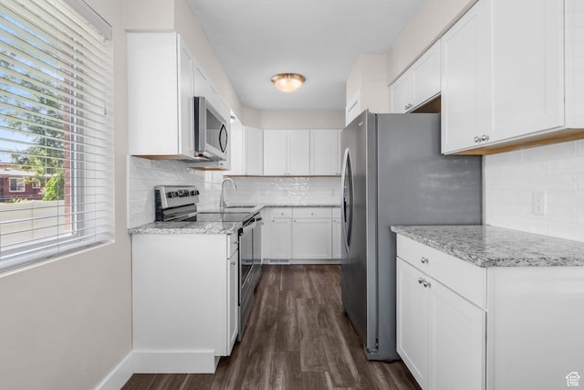 1500 N 350 W, Bountiful, UT 84010 - kitchen featuring appliances with stainless steel finishes, dark wood-type flooring, white cabinetry, and backsplash
