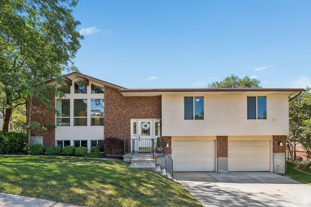784 E 2150 S, Bountiful, UT 84010 - split foyer home featuring a front lawn, brick siding, an attached garage, and driveway