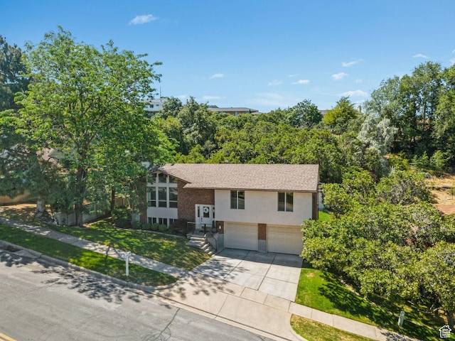 784 E 2150 S, Bountiful, UT 84010 - split foyer home with a garage, driveway, a front lawn, and stucco siding