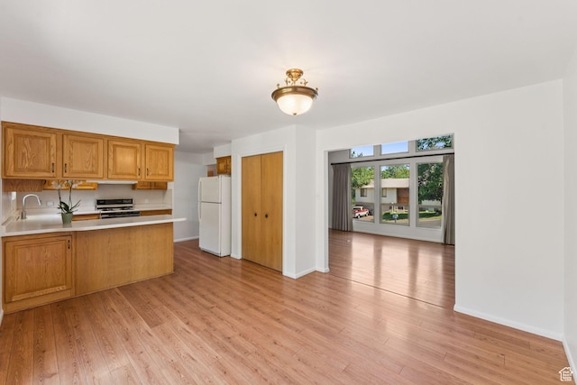 784 E 2150 S, Bountiful, UT 84010 - kitchen featuring a peninsula, white appliances, light countertops, light wood-style flooring, and brown cabinets