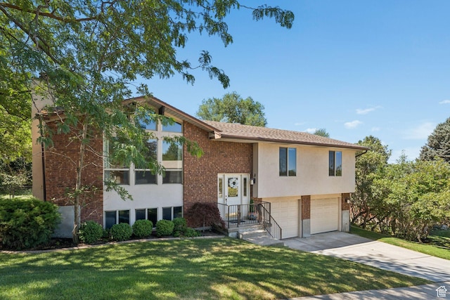 784 E 2150 S, Bountiful, UT 84010 - raised ranch featuring concrete driveway, an attached garage, a front yard, and brick siding