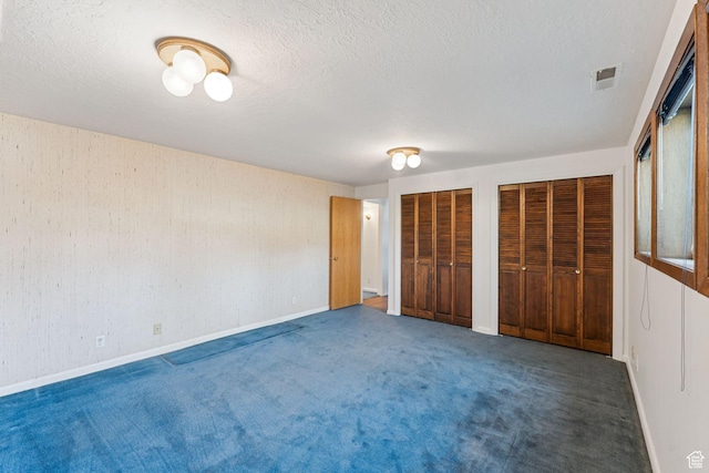 784 E 2150 S, Bountiful, UT 84010 - unfurnished bedroom featuring two closets, carpet flooring, and a textured ceiling