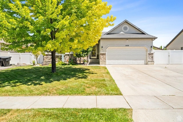 1458 N 2400 W, Clinton, UT 84015 - view of front of house with a gate, concrete driveway, an attached garage, and stucco siding