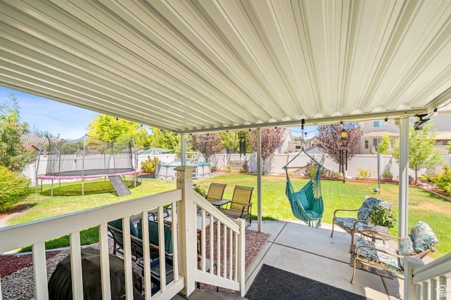 1458 N 2400 W, Clinton, UT 84015 - fenced backyard featuring a trampoline, a patio area, and a residential view