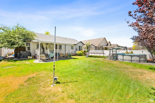 1458 N 2400 W, Clinton, UT 84015 - view of yard featuring a trampoline, a patio, and entry steps