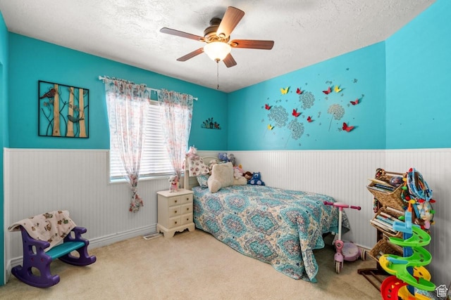 1458 N 2400 W, Clinton, UT 84015 - bedroom featuring a wainscoted wall, a textured ceiling, carpet floors, and ceiling fan