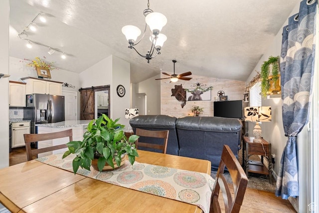 1458 N 2400 W, Clinton, UT 84015 - dining space with a barn door, lofted ceiling, ceiling fan, light wood-type flooring, and rail lighting