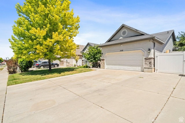 1458 N 2400 W, Clinton, UT 84015 - view of front of house with concrete driveway, an attached garage, and stucco siding