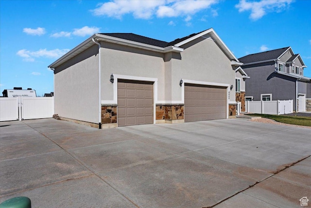 4448 W 5325 S, Hooper, UT 84315 - view of property exterior with driveway, stucco siding, and an attached garage