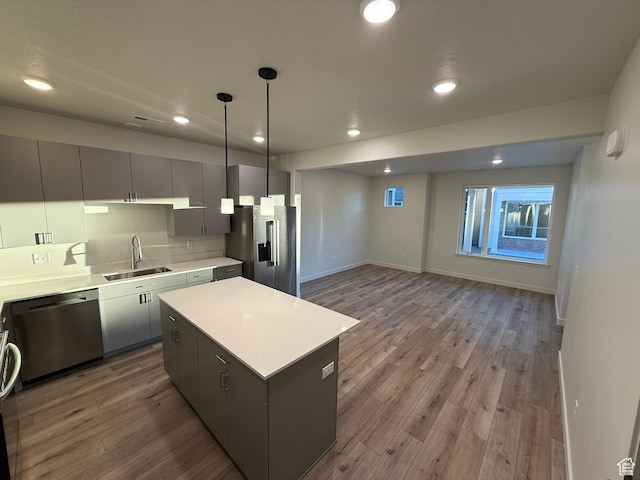 652 E 12225 S Unit 38, Draper, UT 84020 - kitchen with stainless steel appliances, a kitchen island, wood finished floors, recessed lighting, and light countertops