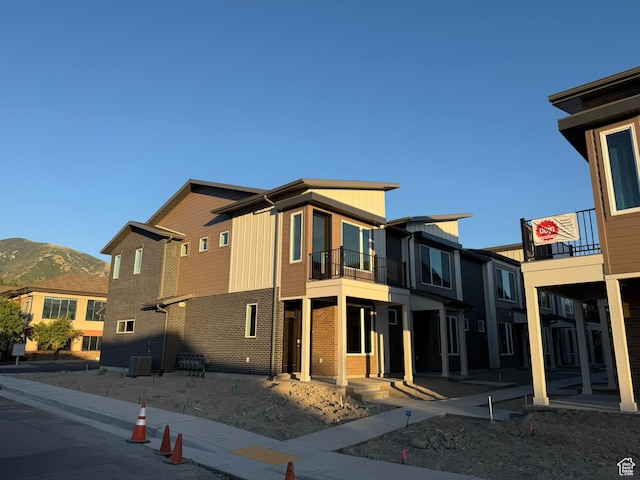 652 E 12225 S Unit 38, Draper, UT 84020 - view of front of home featuring a balcony, a mountain view, brick siding, and board and batten siding