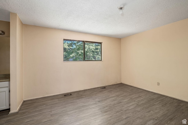 1469 E Winterwood Cir, Sandy, UT 84092 - empty room with wood finished floors and a textured ceiling