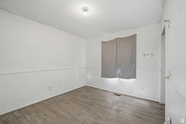 1469 E Winterwood Cir, Sandy, UT 84092 - empty room with wood finished floors and a textured ceiling