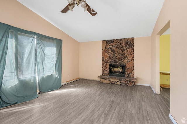 1469 E Winterwood Cir, Sandy, UT 84092 - unfurnished living room with lofted ceiling, a ceiling fan, wood finished floors, and a stone fireplace