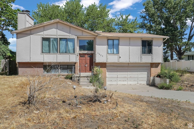 1469 E Winterwood Cir, Sandy, UT 84092 - split foyer home featuring brick siding, concrete driveway, an attached garage, and a chimney