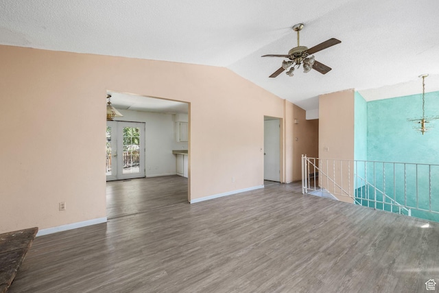 1469 E Winterwood Cir, Sandy, UT 84092 - unfurnished living room with wood finished floors, a ceiling fan, vaulted ceiling, and a chandelier