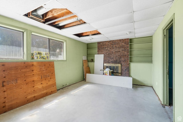 1469 E Winterwood Cir, Sandy, UT 84092 - unfurnished living room with a brick fireplace and concrete floors
