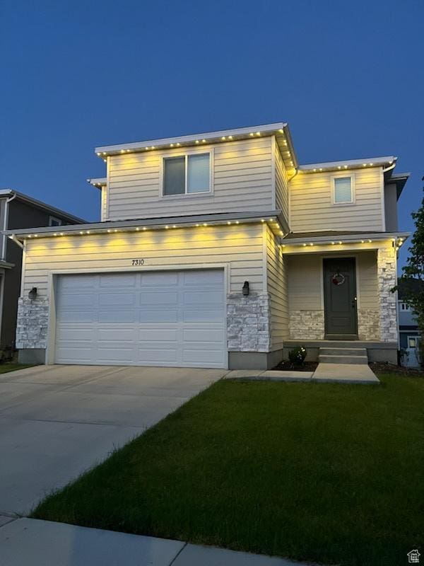 7310 N Green Pasture Ln, Eagle Mountain, UT 84005 - view of front of house featuring concrete driveway, stone siding, and a front yard
