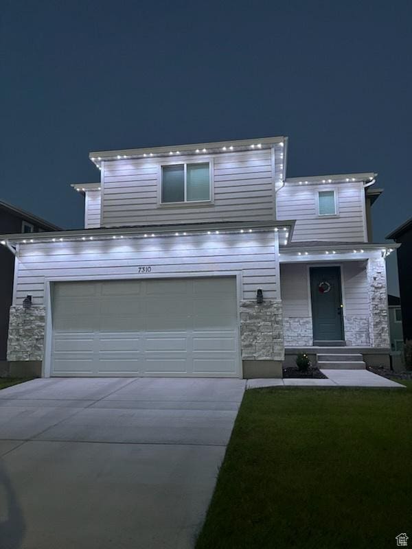7310 N Green Pasture Ln, Eagle Mountain, UT 84005 - view of front of home featuring stone siding, driveway, and a garage