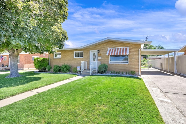 1634 N 350 W, Sunset, UT 84015 - view of front of property featuring a carport, driveway, and brick siding