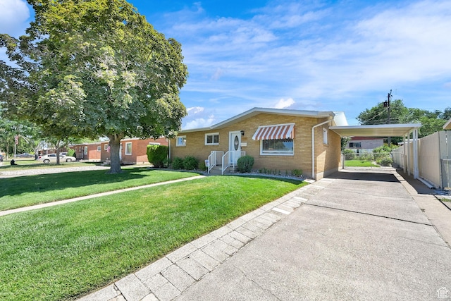 1634 N 350 W, Sunset, UT 84015 - view of front facade with an attached carport, concrete driveway, and brick siding