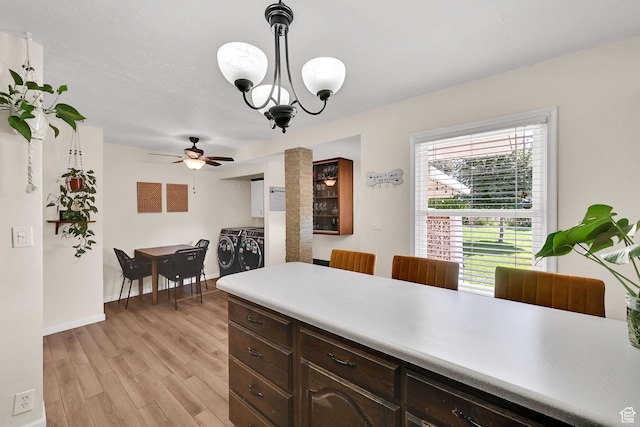 1634 N 350 W, Sunset, UT 84015 - kitchen featuring light countertops, light wood-style floors, dark brown cabinetry, ceiling fan, and a chandelier