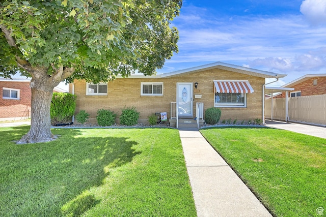 1634 N 350 W, Sunset, UT 84015 - view of front of house with brick siding and a carport