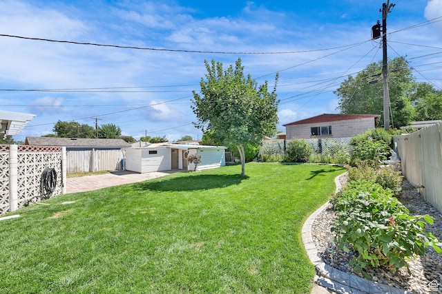 1634 N 350 W, Sunset, UT 84015 - fenced backyard with an outbuilding and a patio area