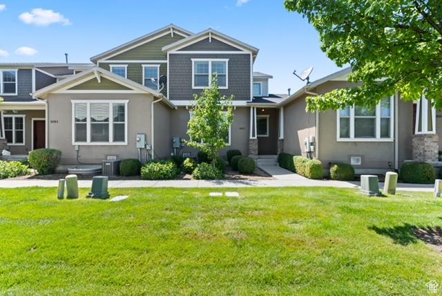 3057 S Finsbury Ln, West Valley City, UT 84120 - back of house featuring a yard and stucco siding