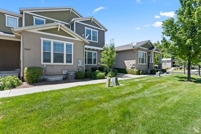3057 S Finsbury Ln, West Valley City, UT 84120 - craftsman-style home with a front yard and stucco siding