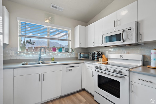 1026 N 1090 W Unit 402, Orem, UT 84057 - kitchen with white appliances, backsplash, light wood-type flooring, and light countertops
