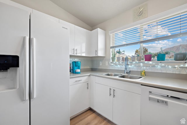 1026 N 1090 W Unit 402, Orem, UT 84057 - kitchen featuring white appliances, decorative backsplash, light countertops, and vaulted ceiling