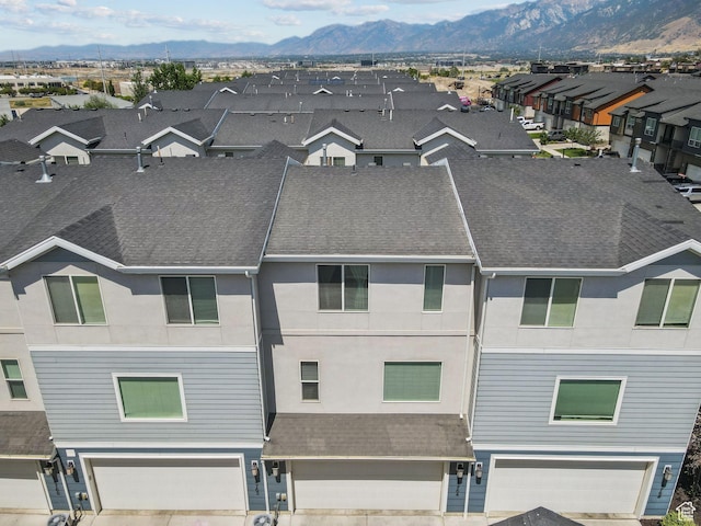 14764 S Rising Star Way W, Bluffdale, UT 84065 - view of front facade with a garage, a mountain view, stucco siding, a residential view, and roof with shingles