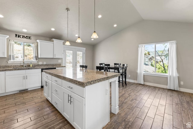 3973 E Eagle Top Ct, Eagle Mountain, UT 84005 - kitchen with wood finished floors, plenty of natural light, a kitchen island, hanging light fixtures, and vaulted ceiling