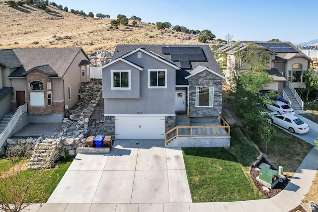 3973 E Eagle Top Ct, Eagle Mountain, UT 84005 - view of front of property with stone siding, a garage, solar panels, concrete driveway, and a front lawn