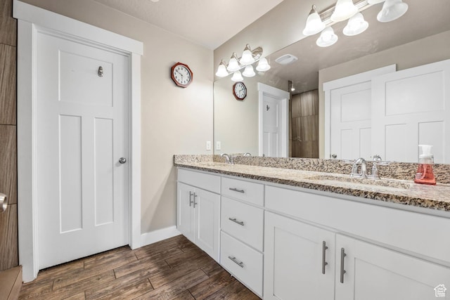 3973 E Eagle Top Ct, Eagle Mountain, UT 84005 - bathroom with double vanity, wood finished floors, and a tile shower