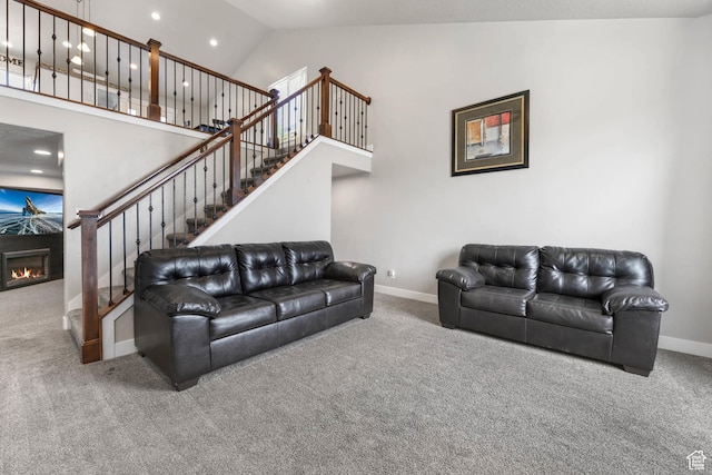 3973 E Eagle Top Ct, Eagle Mountain, UT 84005 - carpeted living area featuring stairs, high vaulted ceiling, a premium fireplace, and recessed lighting