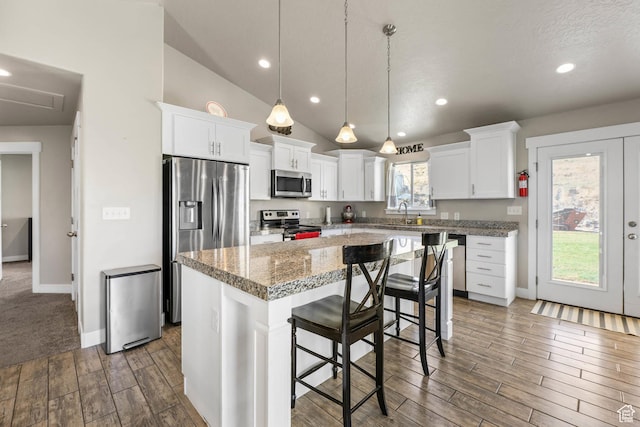 3973 E Eagle Top Ct, Eagle Mountain, UT 84005 - kitchen with a center island, stainless steel appliances, white cabinetry, dark wood finished floors, and lofted ceiling