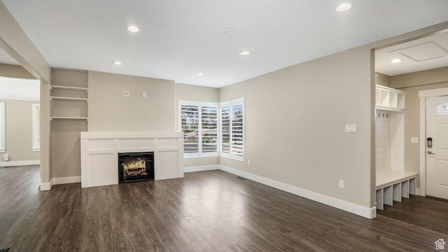 5398 S 2300 W, Roy, UT 84067 - unfurnished living room featuring dark wood-type flooring, recessed lighting, and a warm lit fireplace