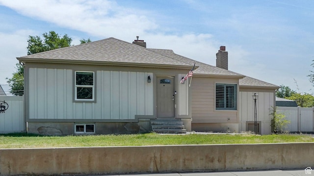5398 S 2300 W, Roy, UT 84067 - view of front of home with entry steps, roof with shingles, board and batten siding, and a chimney