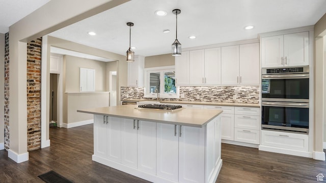 5398 S 2300 W, Roy, UT 84067 - kitchen featuring appliances with stainless steel finishes, backsplash, white cabinets, dark wood-style floors, and recessed lighting