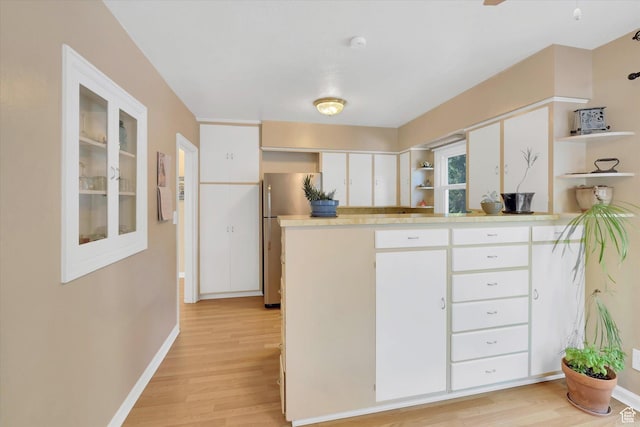 155 W 500 N, Logan, UT 84321 - kitchen with open shelves, light wood-style flooring, freestanding refrigerator, and white cabinets