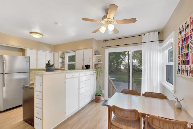 155 W 500 N, Logan, UT 84321 - kitchen with freestanding refrigerator, a peninsula, white cabinetry, and light wood-type flooring