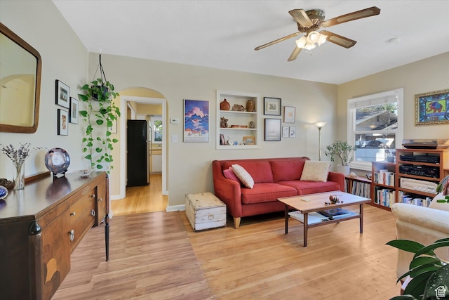 155 W 500 N, Logan, UT 84321 - living room with a ceiling fan, light wood-type flooring, and arched walkways
